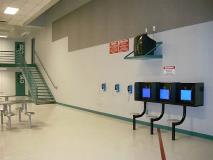 Dayrooms are large common areas where the inmates can watch T.V., play card or board games, talk on the telephones or have a visit on one of the visiting monitors.